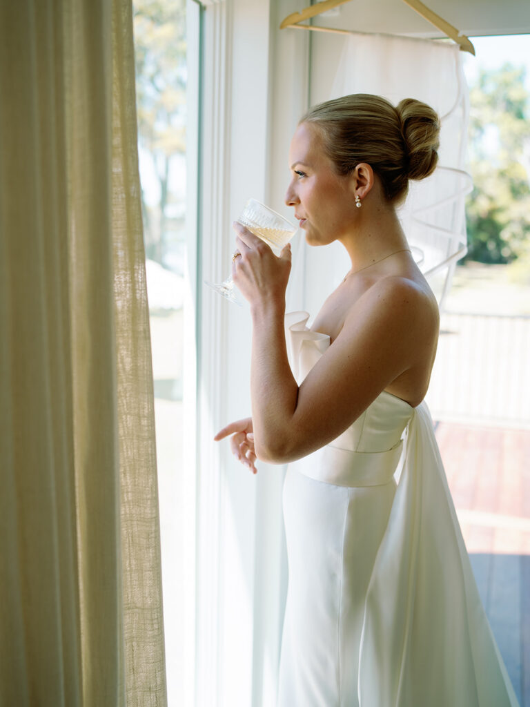 Bride sipping a drink at Orange Grove in Beaufort, SC